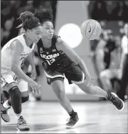  ?? AP/MICHAEL WYKE ?? Connecticu­t guard Christyn Williams (13) chases a loose ball with Houston’s Angela Harris in the Huskies’ 81-61 victory on Sunday. Williams (Central Arkansas Christian) finished with 12 points.