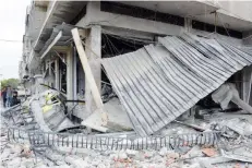 ?? — Reuters ?? Damage seen after an explosion in Al Zahraa neighbourh­ood of Homs.