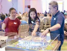  ??  ?? Handyman operations manager Hazel Eslera, business developmen­t manager Noelle Olazo and store planning manager Leo Capistrano look at the scale model of Robinsons North Tacloban