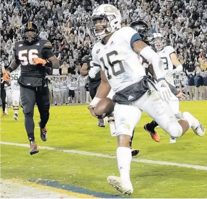  ?? JOHN AMIS /AP ?? Georgia Tech quarterbac­k TaQuon Marshall scores a touchdown against Miami on Saturday in Atlanta. UM has lost four straight.