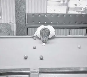  ?? AP ?? WITH a twist of the neck this way, or a lighter nudge another, 32-year-old Mohammad Ikram has worked out how to pot snooker balls without the use of a cue stick.