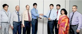  ??  ?? BANK OF CEYLON CHIEF MARKETING OFFICER DR. INDUNIL LIYANAGE (LEFT) EXCHANGING THE AGREEMENT WITH NATIONAL HOSPITAL COLOMBO DIRECTOR DR. ANIL JASINGHE IN THE PRESENCE OF BANK OF CEYLON ASSISTANT GENERAL MANAGER MARKETING W.M.S. WANASINGHE, CHIEF MANAGER...