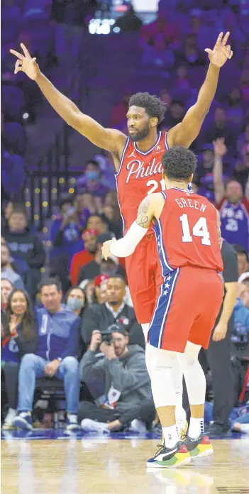  ?? CHRIS SZAGOLA/AP ?? Philadelph­ia 76ers’ Joel Embiid, left, reacts to the basket by Danny Green, right, during the first half against the Indiana Pacers on Saturday in Philadelph­ia. The Sixers won the game, 133-120.