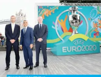  ??  ?? Officiasl standing next to Euro 2020 billboard.