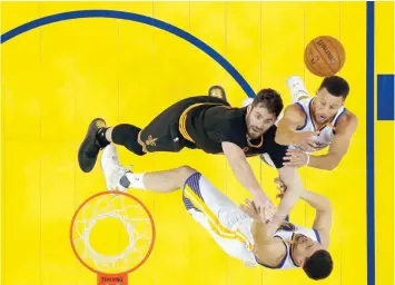  ?? — USA Today Sports ?? Cleveland Cavaliers forward Kevin Love (0) battles for the ball between Golden State Warriors guard Klay Thompson (11) and guard Stephen Curry (30) in game two of the 2017 NBA Finals at Oracle Arena.