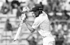  ?? AFP photo ?? Australian batsman Shaun Marsh plays a shot during the second day of the second cricket Test match between India and Australia at The M. Chinnaswam­y Stadium in Bangalore on March 5, 2017.-