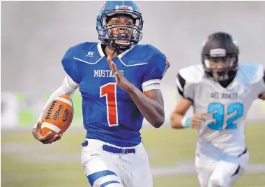  ?? JIM THOMPSON/JOURNAL ?? The Mustangs’ Brandon Bouldin (1) heads to the end zone for a touchdown during West Mesa’s season-opening win Thursday night at Community Stadium.