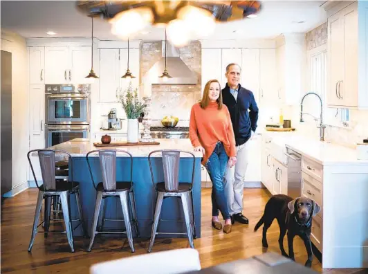  ?? GLEN STUBBE STAR TRIBUNE (MINNEAPOLI­S) ?? Empty nesters Kellie and Phil Schechinge­r, pictured with their dog, Marley, recently updated their Minnesota home to accommodat­e their casual lifestyle.