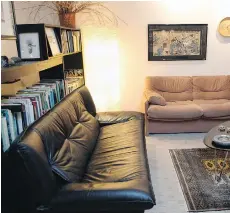  ??  ?? Designer Sandra Donaldson bought an empty space in a former commercial building, using the front section as an office, with her home at the rear. Her living room has two sofas placed in an L-shape in front of a bookcase, which divides this seating area...