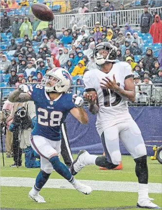  ?? NICK WASS THE ASSOCIATED PRESS ?? Baltimore Ravens wide receiver Michael Crabtree, right, gets ready to pull in a touchdown pass as Buffalo Bills defensive back Phillip Gaines looks on during the first half Sunday. The Bills had a rought start to the season.
