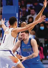  ?? Brandon Wade / Associated Press ?? Luka Doncic, center, and the Mavericks will have their hands full with the Suns in the next round.