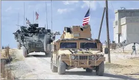  ?? ARAB 24 ?? U.S. forces patrol on the outskirts of the Syrian town, Manbij, a flashpoint between Turkish troops and allied Syrian fighters and U.S.-backed Kurdish fighters.