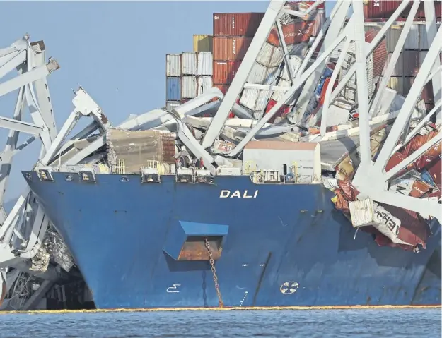  ?? ?? Wreckage from the Francis Scott Key Bridge rests on the Dali cargo ship yesterday