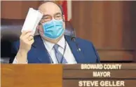  ?? AMY BETH BENNETT/ SOUTH FLORIDA SUN SENTINEL ?? Broward County Mayor Steve Geller holds up a face mask as he speaks during a news conference in the Broward Government­al Center Commission Chambers on Jan. 5.