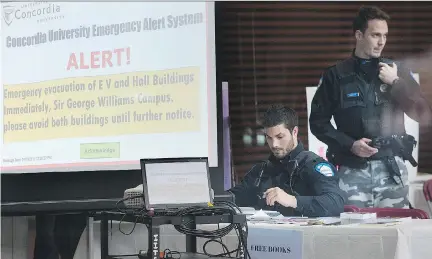  ?? GRAHAM HUGHES/THE CANADIAN PRESS ?? Police officers are posted next to an evacuation alert at Concordia University following Wednesday’s bomb threat. Concordia said it decided on the evacuation order to allow police to search the buildings in question and to ease concern among students...