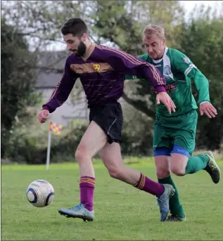  ??  ?? Cian Rossiter of Wexford Albion is chased by Daithí Redmond of Ballymurn Celtic.