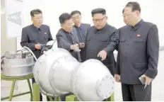  ?? — Reuters file photo ?? North Korean leader Kim Jong Un provides guidance with Ri Hong Sop (2nd L) and Hong Sung Mu (R) on a nuclear weapons programme in this undated photo released by North Korea’s Korean Central News Agency (KCNA) in Pyongyang on September 3, 2017.