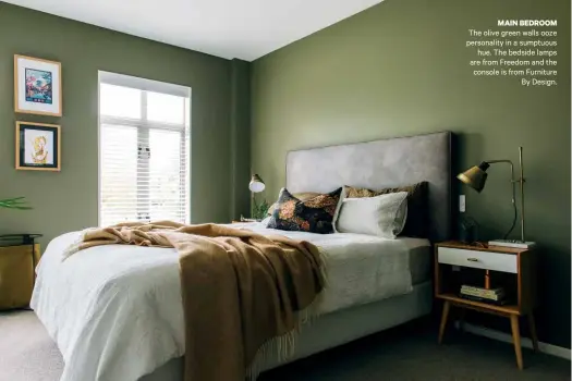  ??  ?? MAIN BEDROOM The olive green walls ooze personalit­y in a sumptuous hue. The bedside lamps are from Freedom and the console is from Furniture By Design.