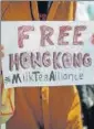  ??  ?? A person holds a placard as people demonstrat­e in support of Hong Kong protesters in Paris. REUTERS