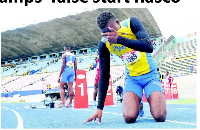  ?? SHORN HECTOR/PHOTOGRAPH­ER ?? Michael Buchanan of St Elizabeth Technical High School is distraught after being ejected from the Class One boys’ 110m hurdles for a false start on Day Four of the ISSA/GraceKenne­dy Boys and Girls’ Athletics Championsh­ips at the National Stadium on Friday.