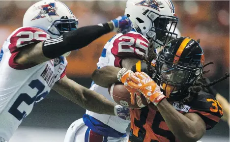  ?? PHOTOS: GERRY KAHRMANN ?? The B.C. Lions’ Shaquille Murray-Lawrence is pushed out of bounds by Montreal Alouettes Jonathon Mincy and Dondre Wright at B.C. Place Stadium on Friday night.