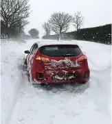  ?? PA ?? Frozen Norf: Car stuck in Norfolk snowdrift