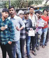  ?? PHOTO: YASIN D ?? Youths wait in queue to cast their vote at Shahpur, in the Walled City area of Ahmedabad, on Thursday