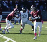  ?? STAN HUDY/THE SARATOGIAN ?? Burnt Hills-Ballston Lake senior quarterbac­k Michael Manning rolls out on a pass play, pursued by Mohonasen’s Jared Hawkins Saturday in Class A play.