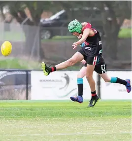  ?? ?? Warragul’s Saxon Cook thumps the ball forward.