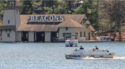  ?? TORK MASON/USA TODAY NETWORK-WISCONSIN ?? A pontoon boat motors across the water Wednesday on Minocqua Lake in Minocqua.