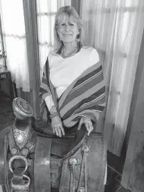  ??  ?? Wanda Garner Cash poses with Pancho Villa's saddle that, for many years, resided in the Cadillac Bar dining room in Nuevo Laredo.