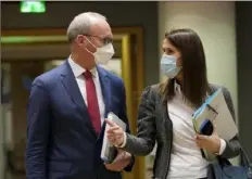  ?? Virginia Mayo/Associated Press ?? Ireland’s Foreign Minister Simon Coveney speaks with Belgium’s Foreign Minister Sophie Wilmes during a meeting of EU foreign ministers at the European Council building Monday in Brussels.