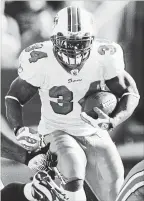  ?? JACK DEMPSEY THE ASSOCIATED PRESS ?? Miami Dolphins running back Ricky Williams breaks through a hole against the Denver Broncos in 2008.