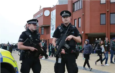  ?? AP PHOTOS ?? ON THEIR GUARD: Armed police stand guard, above, outside Celtic Park in Glasgow, Scotland, yesterday, a day after a bomb detonated in a London subway. Police probe an area in southwest London, below.