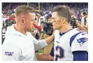  ?? WESLEY HITT/GETTY IMAGES ?? J.J. Watt, left, then with the Houston Texans, talks with quarterbac­k Tom Brady of the Patriots after a game on Dec. 1, 2019, in Houston.