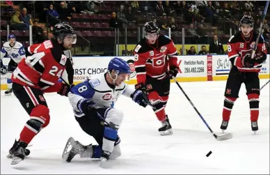  ?? DAVID CROMPTON/Penticton Herald ?? Penticton Vees forward Nicholas Jones goes to one knee to corral the puck against Merritt Centennial­s’ Zachary Bleuler, left, Michael Regush and Tyler Ward during Game 2 of their second-round BCHL playoff series on Saturday at the SOEC. The Vees won 4-1 to take a 2-0 lead in the best-of-seven.