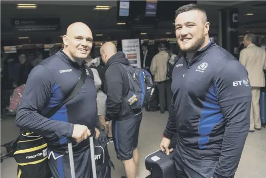  ??  ?? 2 Scotland’s Gordon Reid, left, and Zander Fagerson check in at Edinburgh Airport prior to flying out to Singapore, where they were greeted by temperatur­es approachin­g 40C.