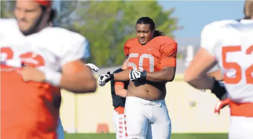  ?? JOURNAL FILE ?? University of New Mexico offensive lineman Teton Saltes (50), regarded as one of the most athletic players on the team, delivers food and water to his neighbors, the people in his community of the Oglala Lakota Tribe on the Pine Ridge Reservatio­n in South Dakota.