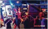  ?? STEFANO PAGLIARINI / ANCONA TODAY ?? Rescuers help injured people early Saturday outside a nightclub in Corinaldo, Italy. Six people died in a stampede of panicked concertgoe­rs.