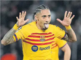  ?? L E W I S J O LY THE ASSOCIATED ?? Barcelona's Raphinha celebrates after scoring his side's opening goal on Wednesday against Paris Saint-Germain at the Parc des Princes.