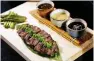 ??  ?? Robata-grilled wagyu with three sauces