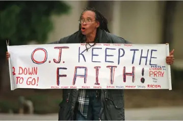  ??  ?? AN O.J. SIMPSON supporter (left) stands outside the Santa Monica Courthouse during Simpson’s civil trial in 1997, two years after his acquittal in a criminal trial. Right: Elor Azaria supporters hold placards in Tel Aviv on April 19, 2016.