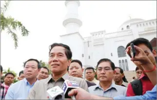  ?? HENG CHIVOAN ?? Khuong Sreng, deputy governor of Phnom Penh, speaks outside the city’s Boeung Kak mosque yesterday.