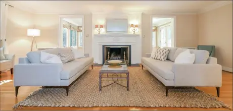  ?? Photos by PlanOmatic ?? Above: The living room at 1080 Ridge Road features hardwood floors and a wood-burning fireplace. Below: Built in 1938, the Colonial Revival-style home is nestled among other fine homes in Hamden’s highly sought-after area of Spring Glen