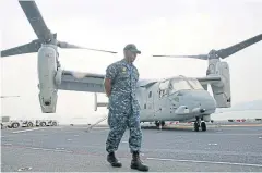  ?? AP ?? A US Marine crewman stands in front of a Marine Medium Tiltrotor Squadron on the flight deck of the ‘USS Bonhomme Richard’ in Hong Kong.