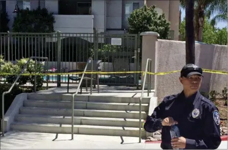  ?? JULIE WATSON — THE ASSOCIATED PRESS ?? A police officer stands outside the pool area at an apartment complex Monday where a deadly shooting occurred Sunday.