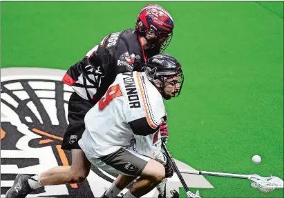  ?? SARAH GORDON/THE DAY ?? Reilly O’Connor of the New England Black Wolves, front, picks up a loose ball against Calgary during the 2018 season at Mohegan Sun Arena.