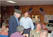  ?? John Popham ?? New commander of the American Legion Post Eddie Hines (left) talks with County Commission­er Scotty Hancock (center) and other community leaders during Saturday night’s officer ceremony at the posts Shorter Avenue headquarte­rs.