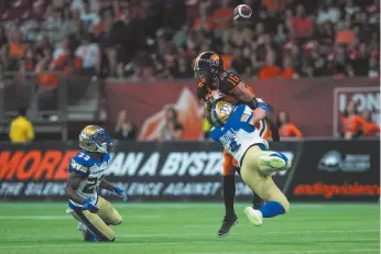  ?? CP PHOTO BY BEN NELMS ?? Winnipeg Blue Bombers’ Adam Bighill (4) breaks up a pass intended for B.C. Lions’ Bryan Burnham (16) during CFL football action in Vancouver on Saturday.