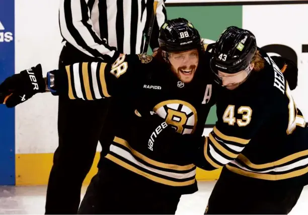  ?? DANIELLE PARHIZKARA­N/GLOBE STAFF ?? David Pastrnak (left) completed his hat trick against the Senators in the third period with his 44th goal of the season . . .